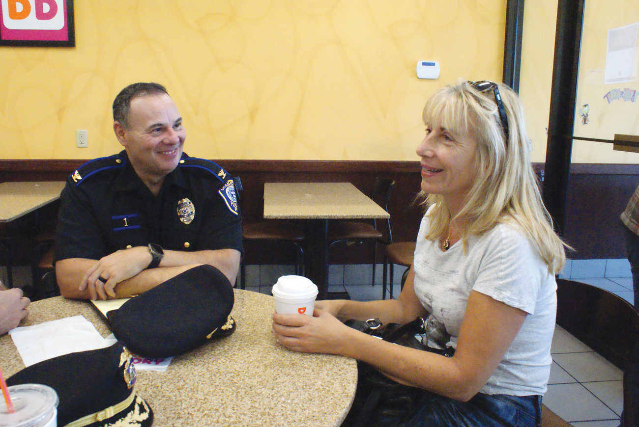 DISCUSSING DOGS: Suzanne Arena sat down with Chief of Police Col. Michael Winquist during the Coffee with a Cop gathering to discuss a recent incident involving a dog bite in her neighborhood.