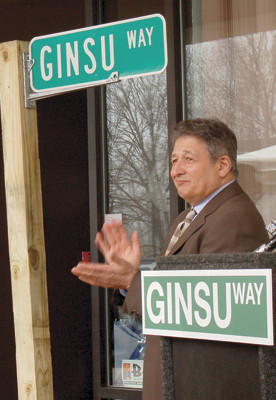 CUTTING THROUGH: Ed Valenti applauds as the official Ginsu Way street sign was unveiled.
