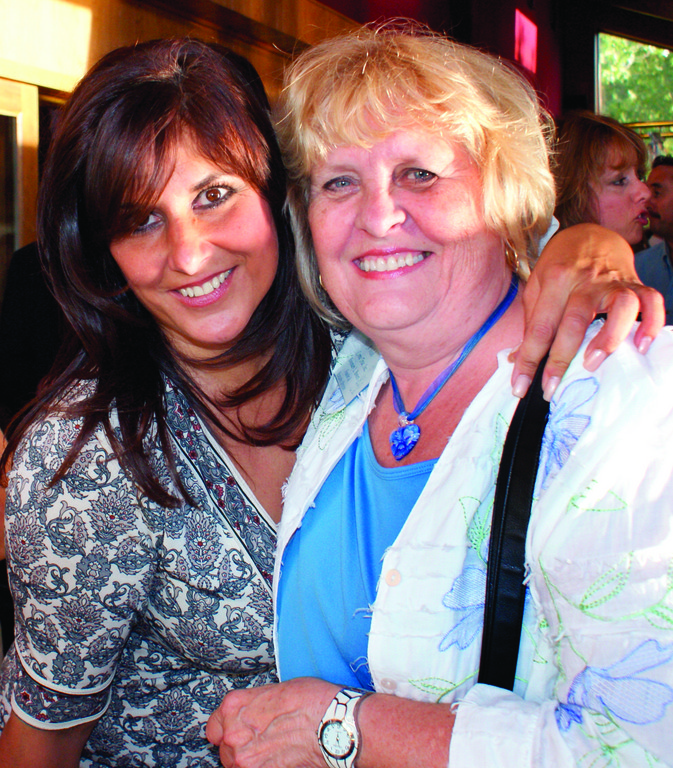 CONNECTING WITH FRIENDS: Pat Paolino, hostess of the networking evening at Twin Oaks and owner of Southern New England Woman Magazine, greets Rosemary L. Bowers, founder and executive director of A Wish Come True, Inc.