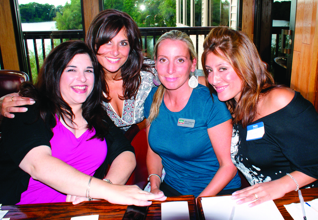 ALL SMILES: Manning the registration table are Anna Maria Angelosanto, founder of Extraordinary Child; Pat Paolino, hostess for the evening and owner of Southern New England Woman Magazine; Dina Caldarone from Marriot Courtyard; and Carol Nenez of the Providence School Department.