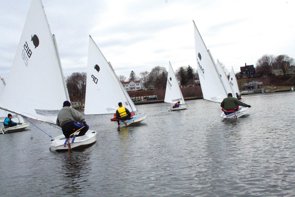 SQUEEZED AT THE START: Ghosting along in whatever zephyrs they were fortunate enough to find, Sunfish sailors vie for the preferred spot on the starting line.