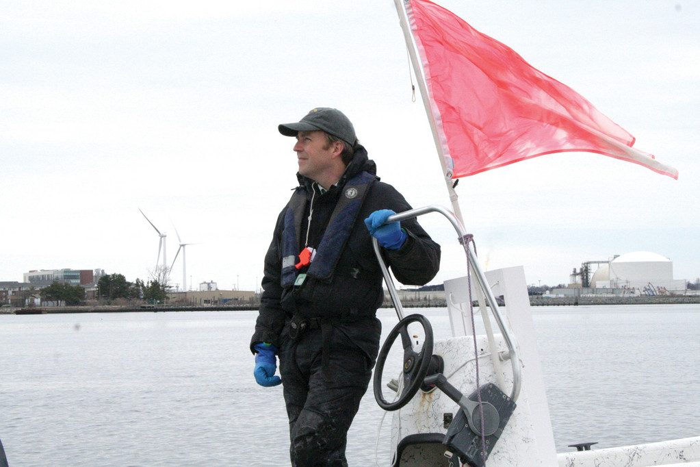 MAN WITH THE COUNT: Stuart Malone, appropriately attired for winter conditions, manned the race committee boat, giving countdowns for the start of each race and keeping score as boats crossed the finish line.