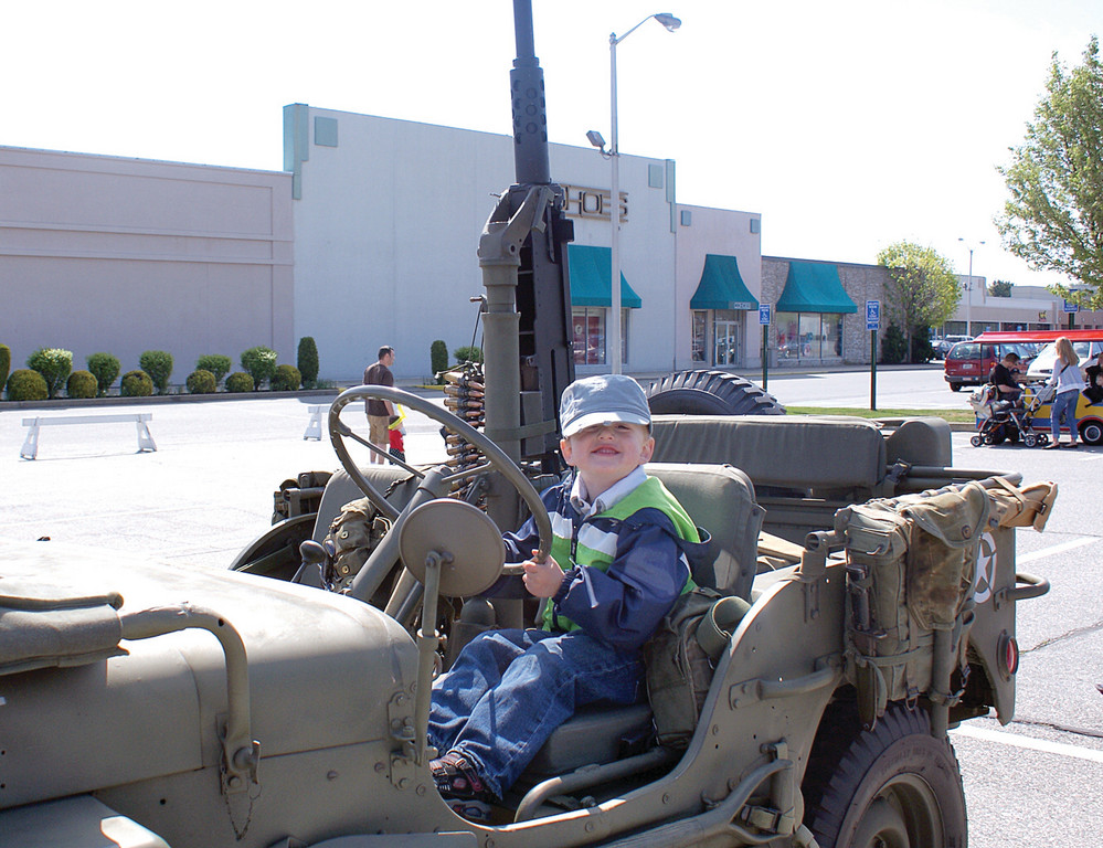 RIDE OF A LIFETIME: Derek Mallon, age 3, gets behind the wheel of a 1942 Jeep that was used in Europe during World War II and was used by the British and Canadian troops during the Battle of the Bulge.