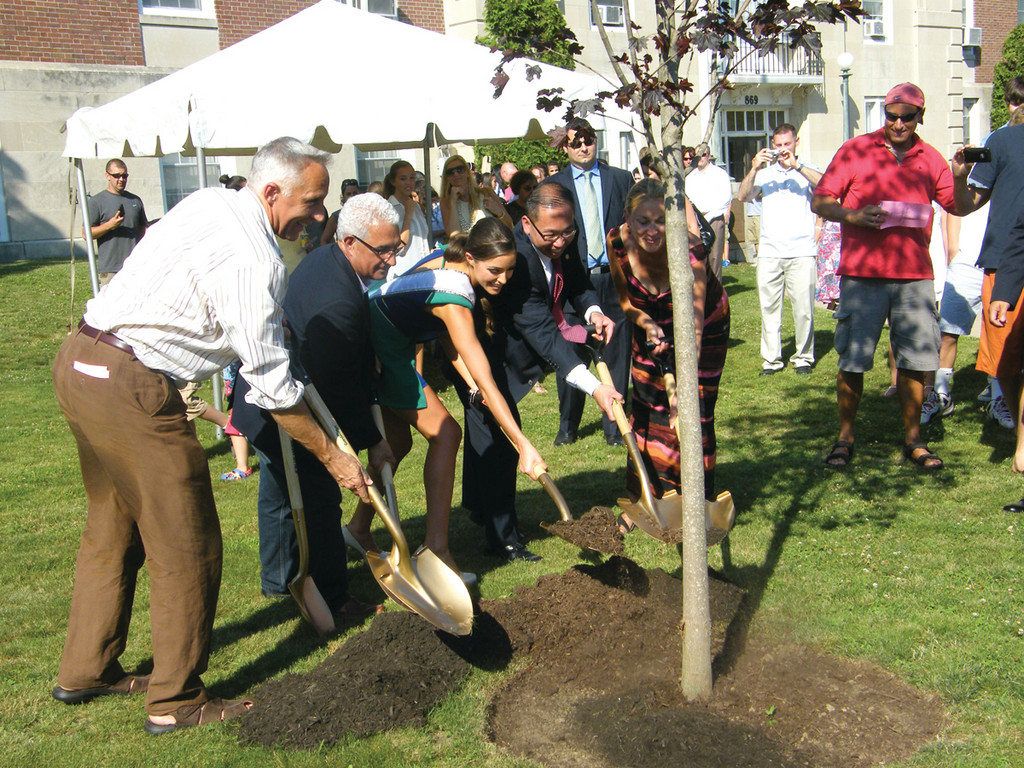 SMILES AND SHOVELS: From left, Peter Culpo, Cranston City Council President Anthony Lupino, Miss USA Olivia Culpo, Cranston Mayor Allan Fung and Susan Culpo scoop shovelfuls of dirt and “plant” a tree in Olivia’s honor in front of Cranston City Hall.