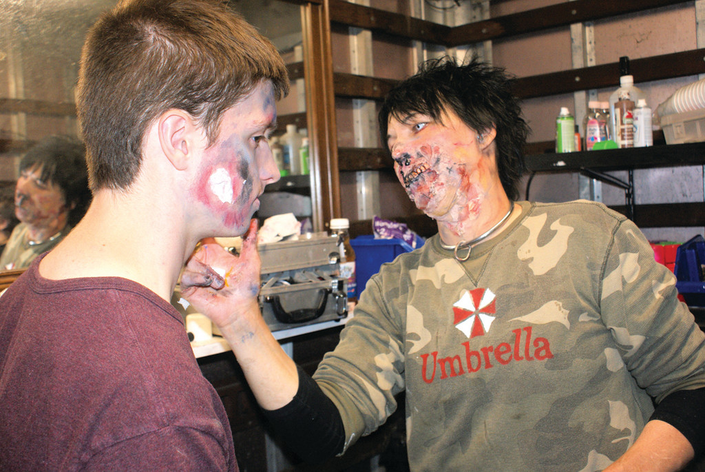 TOUCHING UP: Rachel Miller adds make-up for ghoul Timothy Flannery.