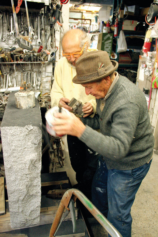 FATHER & SON: Anthony Sciolto and his son Anthony R. Sciolto work as a team at the Cranston monument company that bears their names. At 95, the senior Sciolto still drives a forklift, as he did for the installation of the Warwick memorial for the victims of the Station Nightclub fire, and works daily. He followed in the footsteps of his father, Vito, who came to this country from Italy, although his father died before he got to see his son's business.