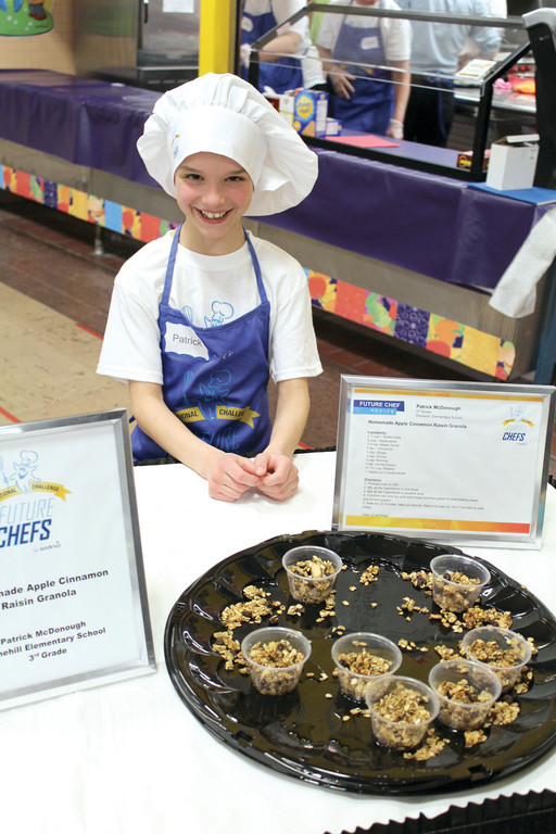 DELICIOUS SNACK: Patrick McDonough, third-place winner in this year’s competition, poses with his “Homemade Apple Cinnamon Raisin Granola,” which included applesauce, raisins, maple syrup, oats and a variety of spices in its ingredients.