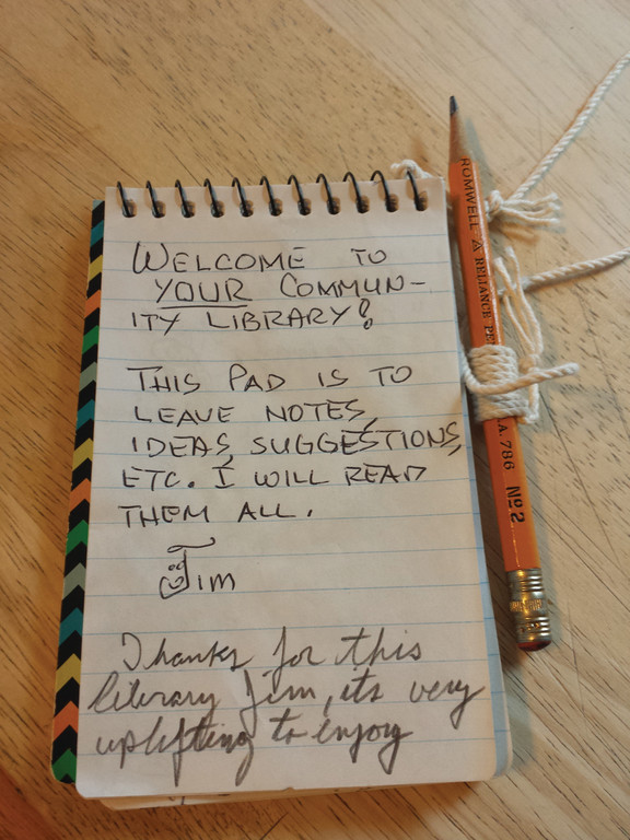 PLEASE LEAVE A MESSAGE: Jim Rigg placed a little notebook into the library on the very first day it was open, and asked people to leave a message when they visit.