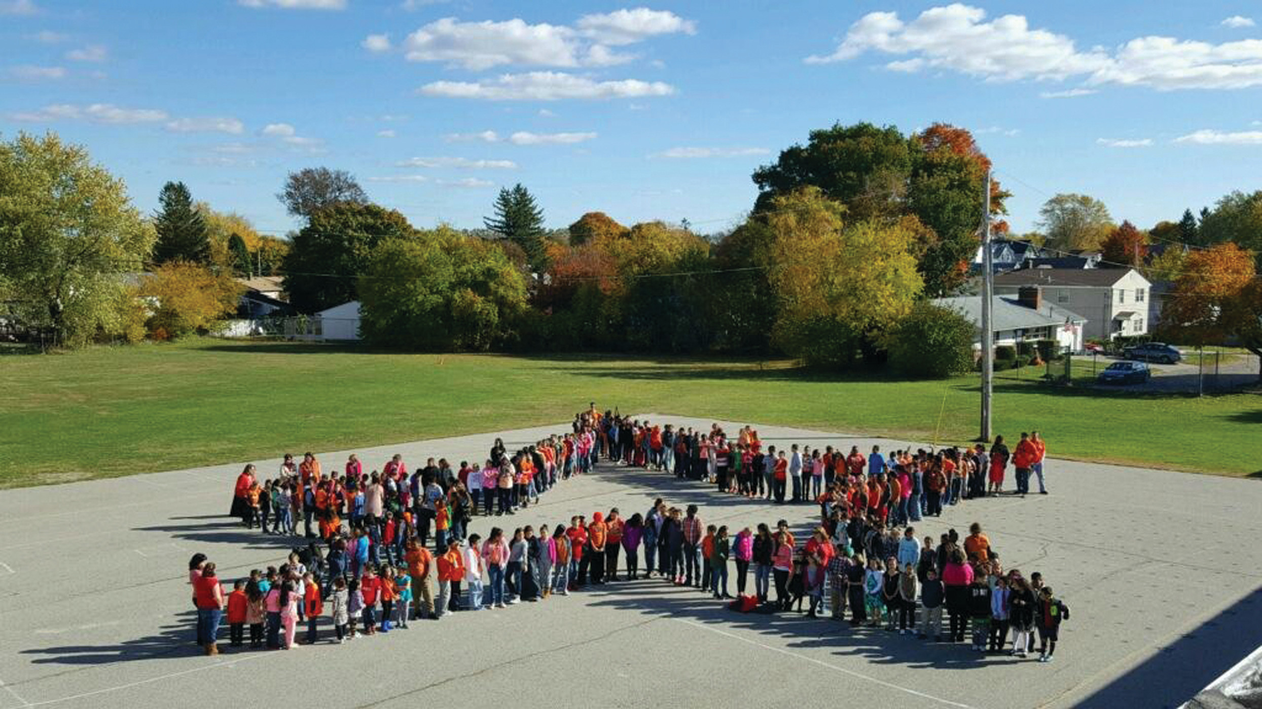 ‘ORANGE’ SPIRIT SHINES: Schools across the city recently took part in the “Go Orange” drive to collect funds and food for the No Hungry Kid campaign. Above, Arlington Elementary School students showed their “Go Orange” spirit on Oct. 30 by forming a giant star on the blacktop outside the school.