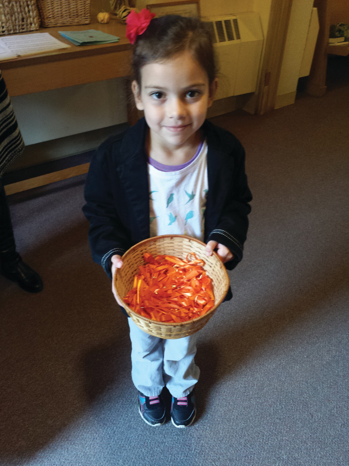A RIBBON OF THANKS: At the St. David’s on the Hill Youth Sunday services on Nov. 1, Carina Hutnak handed out orange ribbons created by the Sunday school students to the parishioners as they dropped off their donations for the Interfaith Food Pantry.