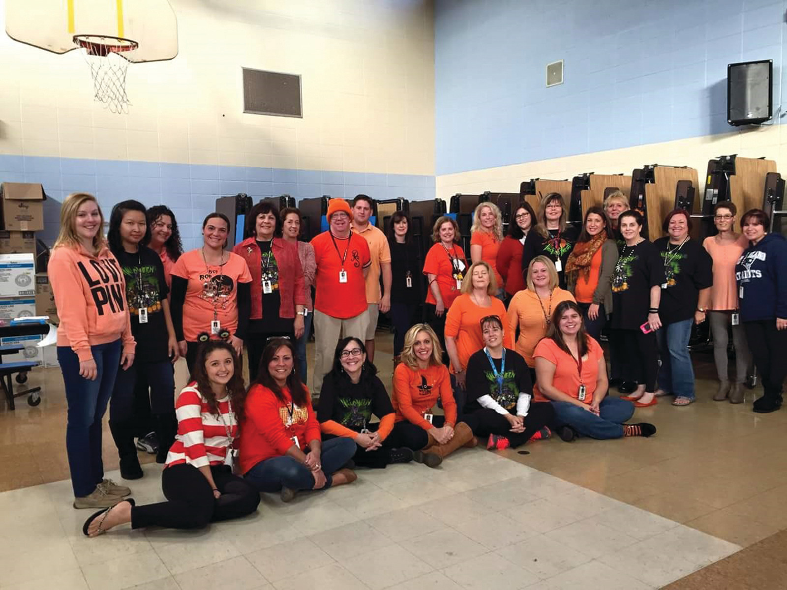 PART OF THE SOLUTION: The staff at Edgewood Highland Elementary School show off their bold orange colors on Oct. 30 as part of their efforts to raise awareness about childhood hunger in America and in the city of Cranston.