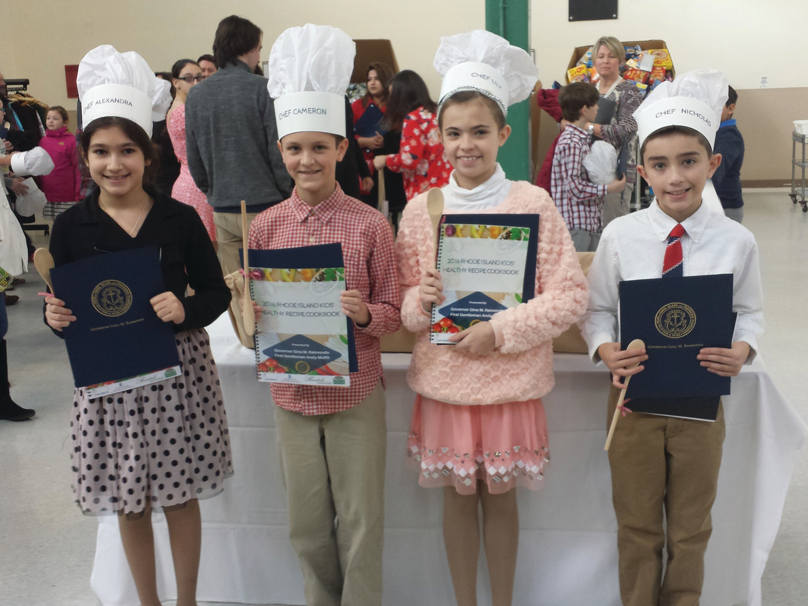 REPRESENTING THE CITY: The Cranston winners and finalists took a moment out of their celebration to pose together in their chefs hats with their cookbooks and citations. Pictured, from left, are fifth-graders Alexandra Cowart, Cameron Belisle, Lily Addonizio, and Nicholas Soccio.
