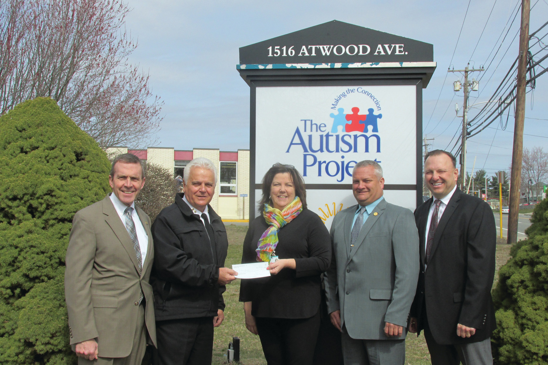 GIFT GIVERS: Johnston Police Chief Richard S. Tamburini presents a $1,000 check to Joanne Quinn, executive director of The Autism Project. He is joined by U.S. Marshal Jamie Hainsworth, Police Chiefs Association Executive Director Sid Wordell, and Johnston Deputy Chief Daniel O. Parrillo.