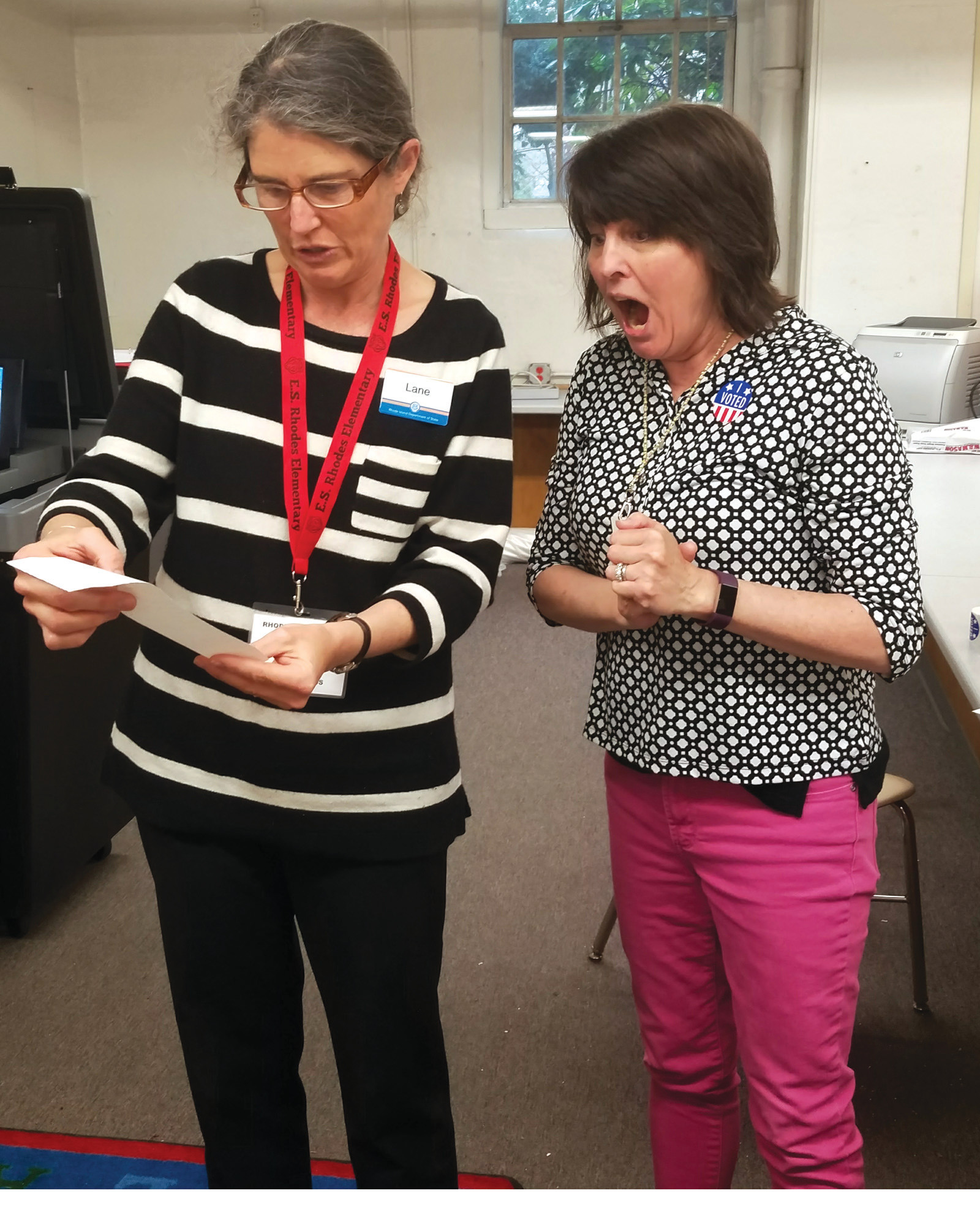 THE VOTES ARE IN: Lane Sparkman, representing the office of the Secretary of State, gives fourth-grade teacher, Susan Weber, the results of the school-wide election. The horseshoe crabs took the win by a landslide, 169 to 40 votes.