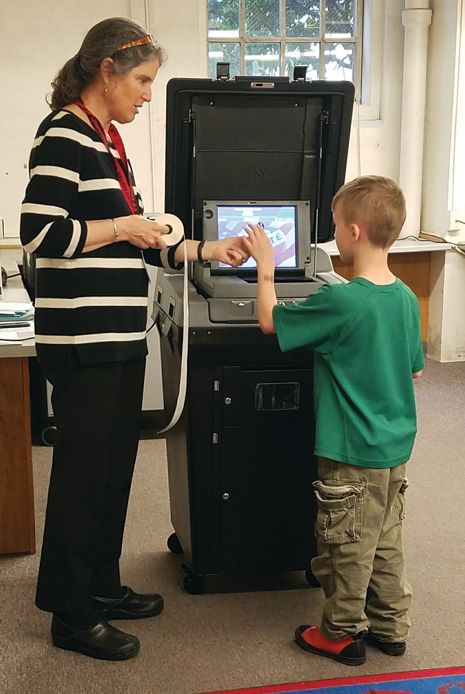 AN AUTHENTIC ELECTION: All staff and students were given the opportunity to vote, using real ballots and a real voting machine, casting their votes in completely privacy. Students were given an "I voted" sticker after casting their ballots.