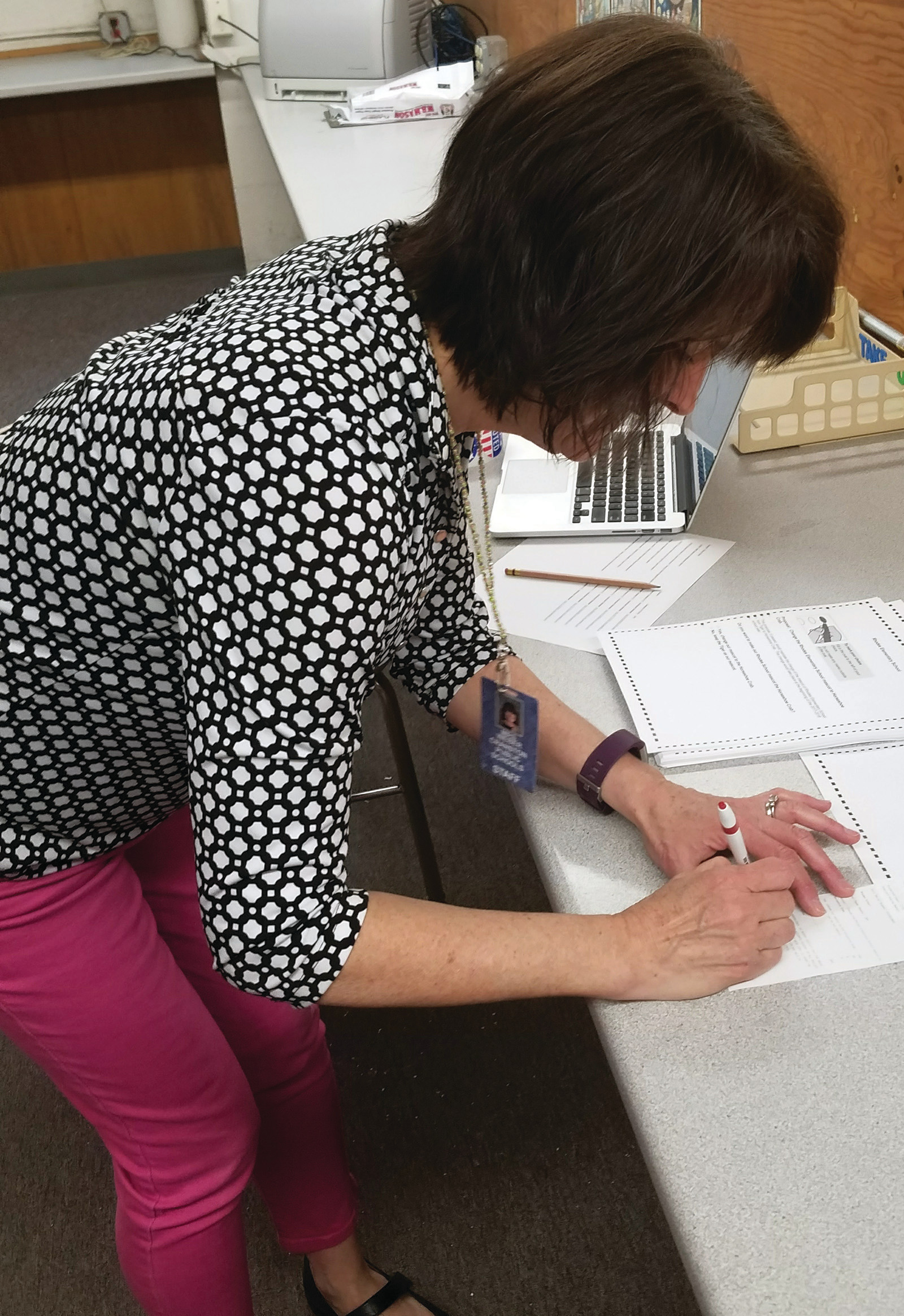 SIGNING OFF: Sue Weber signs off on the final results, just as in a real election.