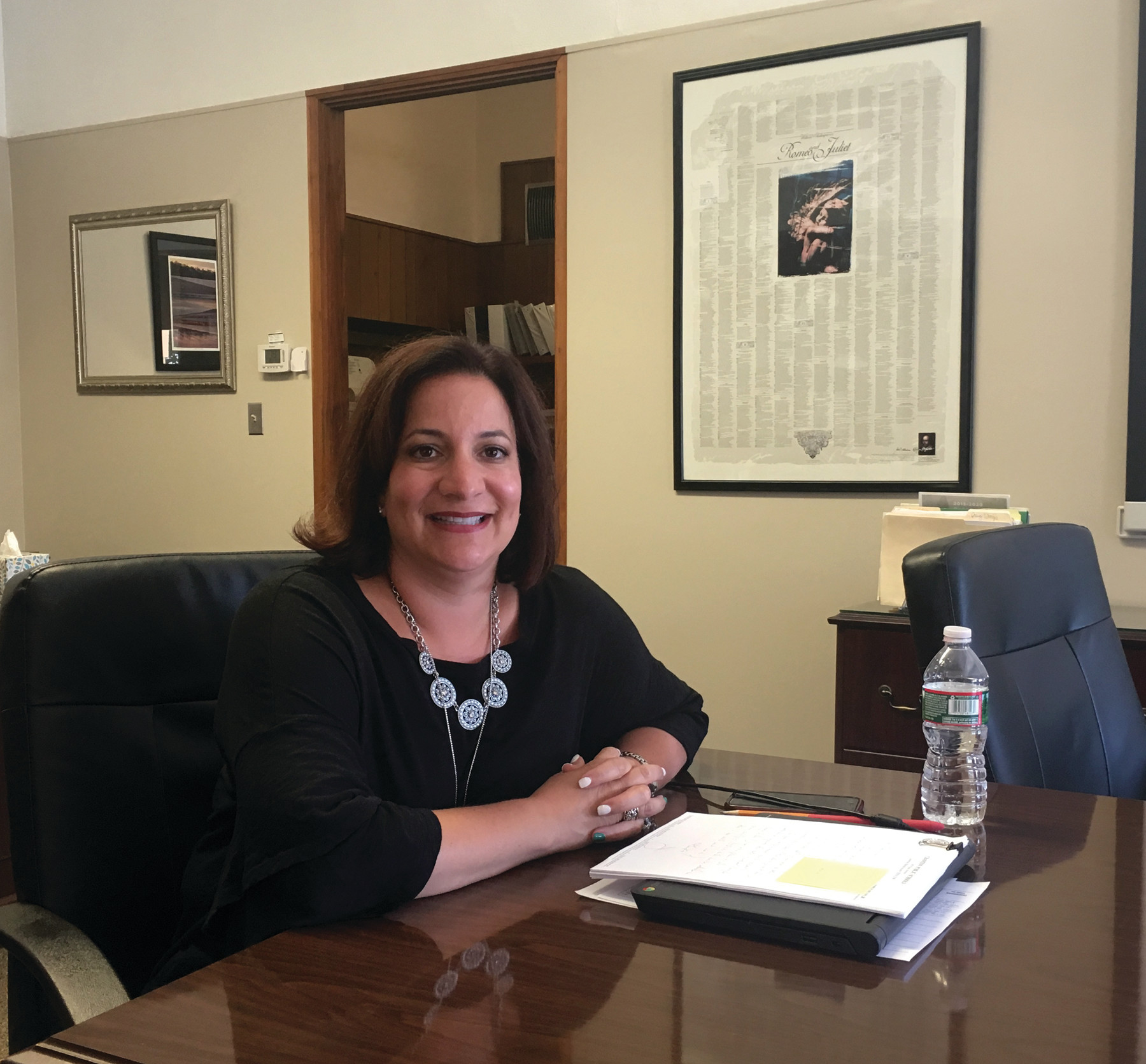 CLOSE TO HER ROOTS: Cranston Superintendent Jeannine Nota-Masse, a former English teacher, has a poster with the entirety of Romeo and Juliet on the wall in her office.