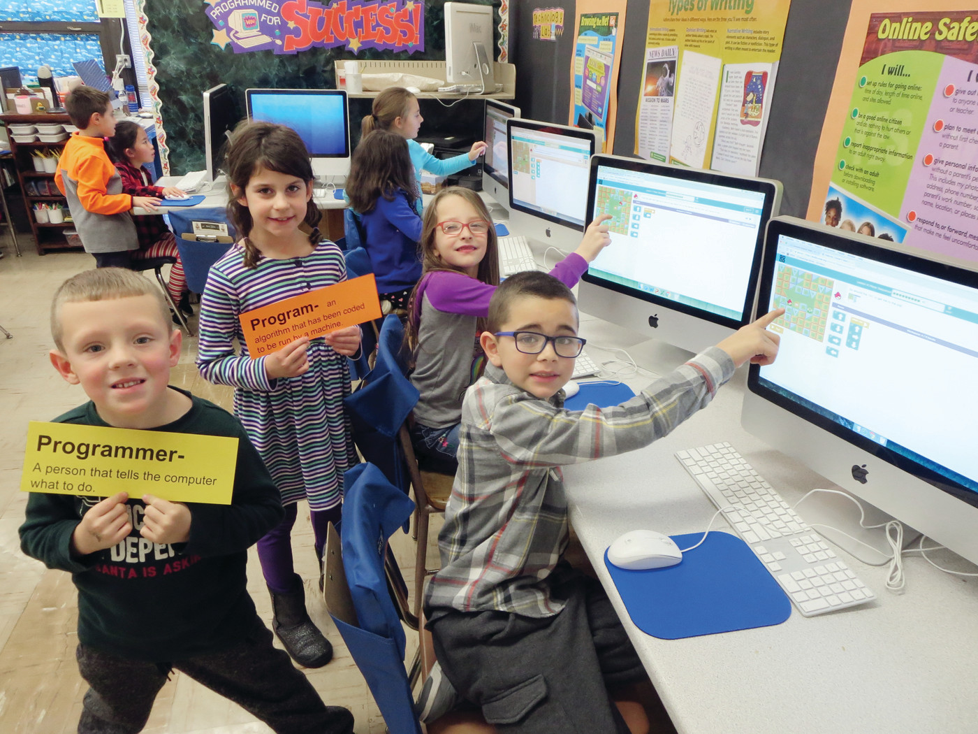 CERTIFIED PROGRAMMERS: Woodridge Elementary students apply what they’ve learned about computer science terminology to their coding games.