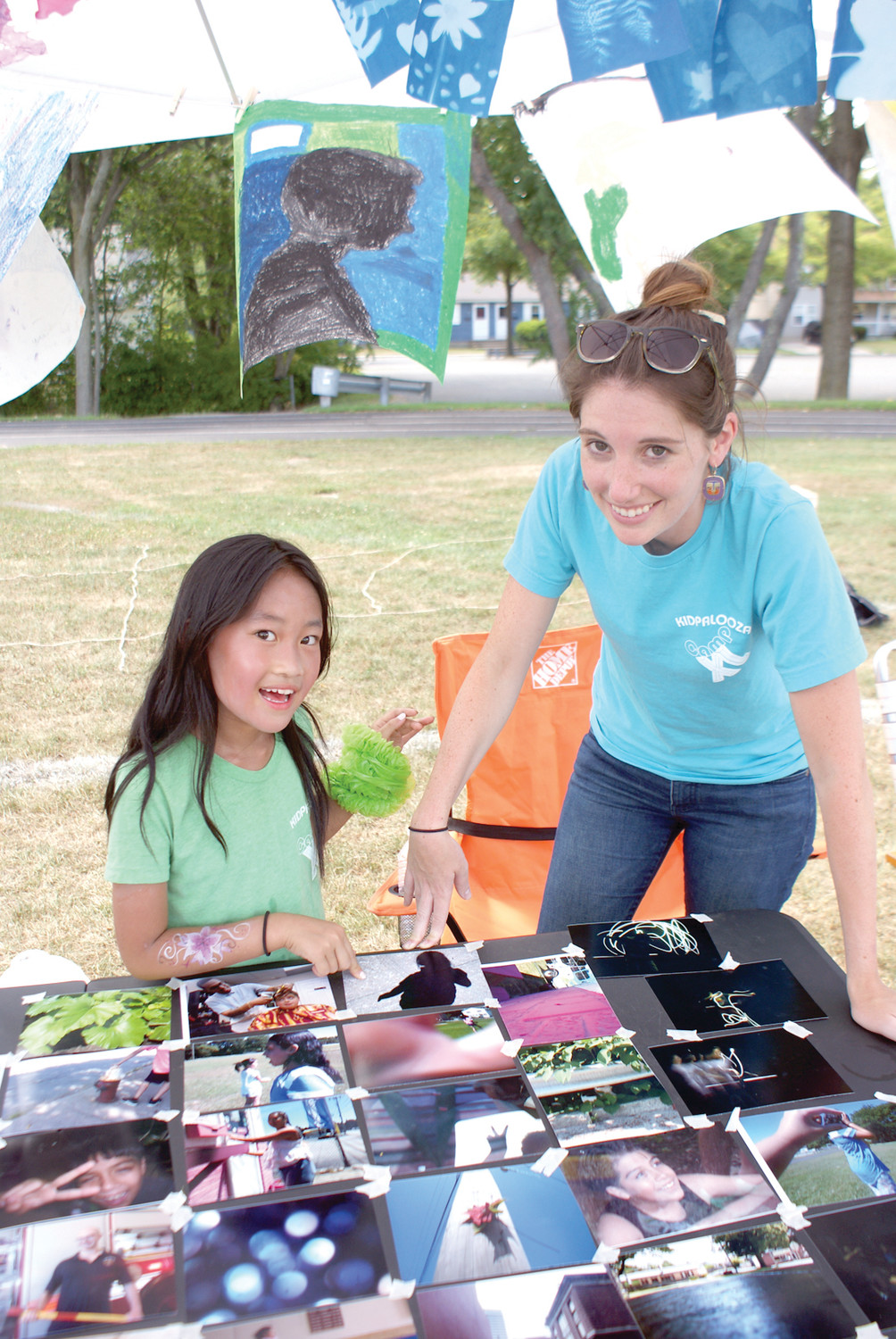 PHOTO GROUP: Amanda Chen, age 9, is pictured with her Photography Instructor from Camp XL, Alicia Turbitt. They highlighted photographs and silhouettes by camp members.