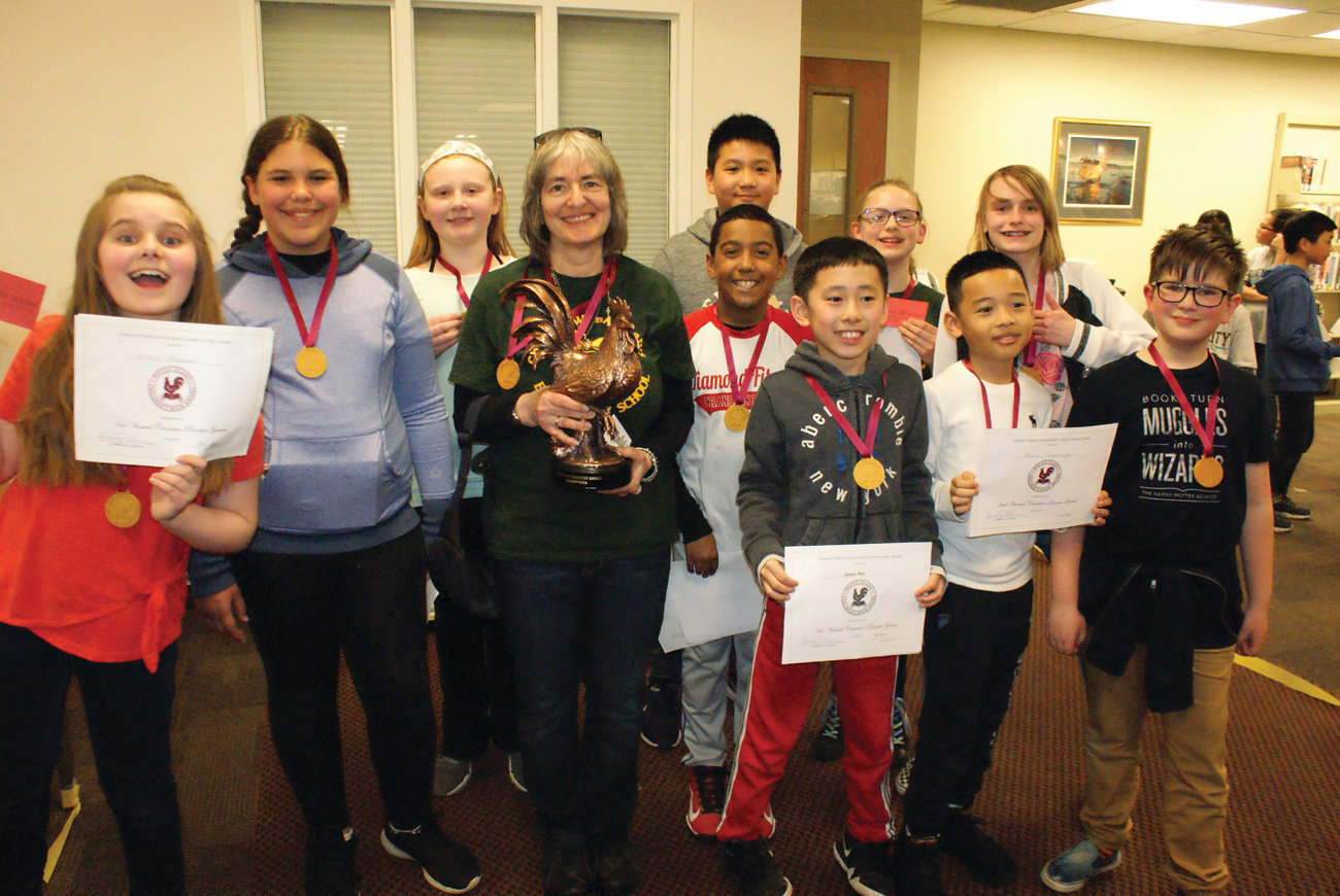 RULERS OF THE ROOST: Students from Chester W. Barrows Elementary School won top honors in The Rooster Games held April 11 at the Central Library. They are pictured with Sue Rose, the school’s librarian.