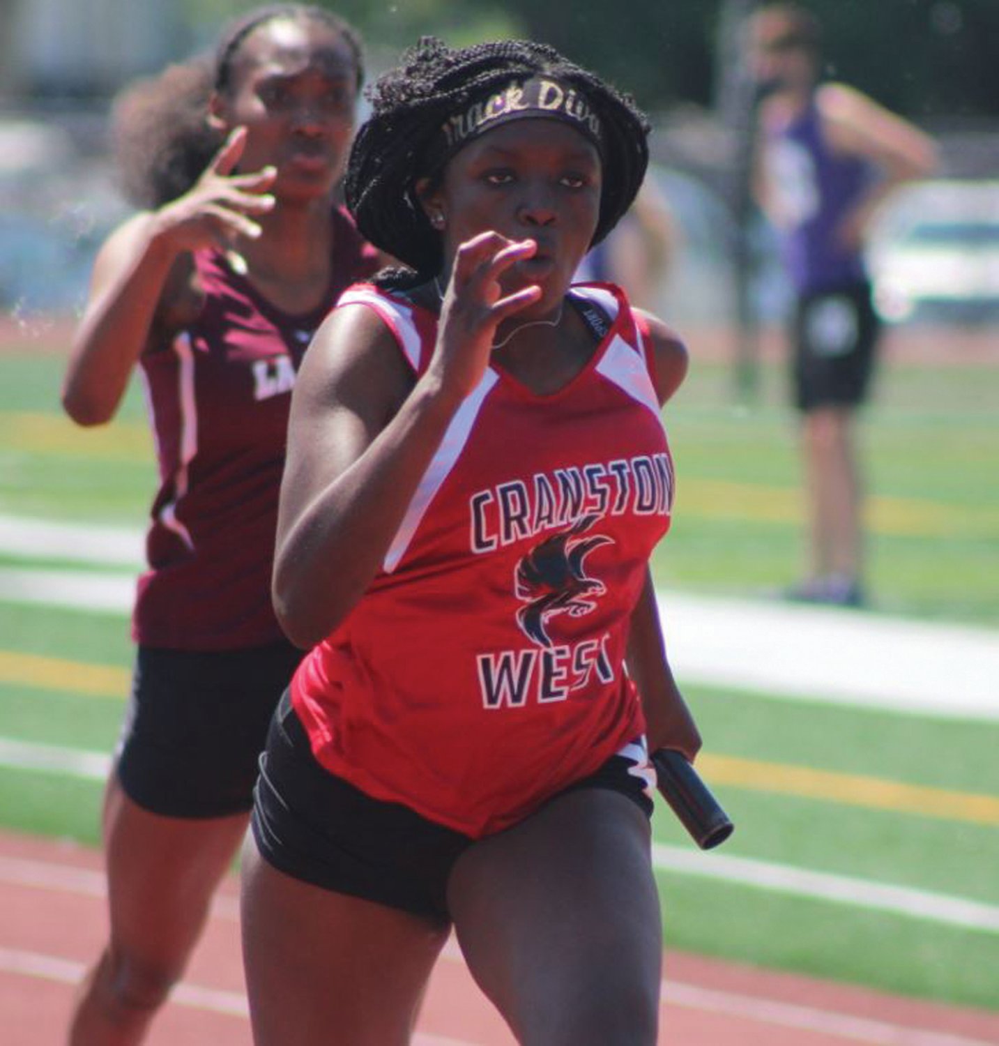RELAY RACE: Cranston West sprinter Ailani Sutherland
competes in a relay race in the Division Championships
last weekend at Conley Stadium in Providence. Sutherland was part of the team that won the 400 which was key in the Lady Falcons claiming third place overall as a team.