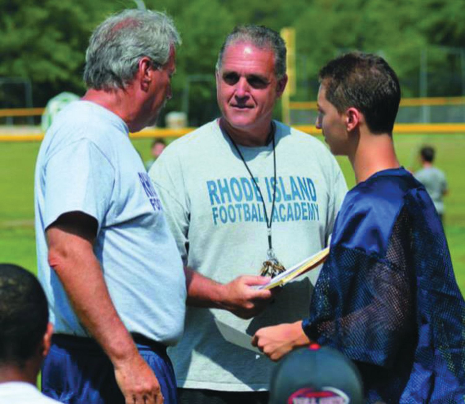 MAKING A DIFFERENCE: Tom Centore (center) while
working at the RI Football Academy.