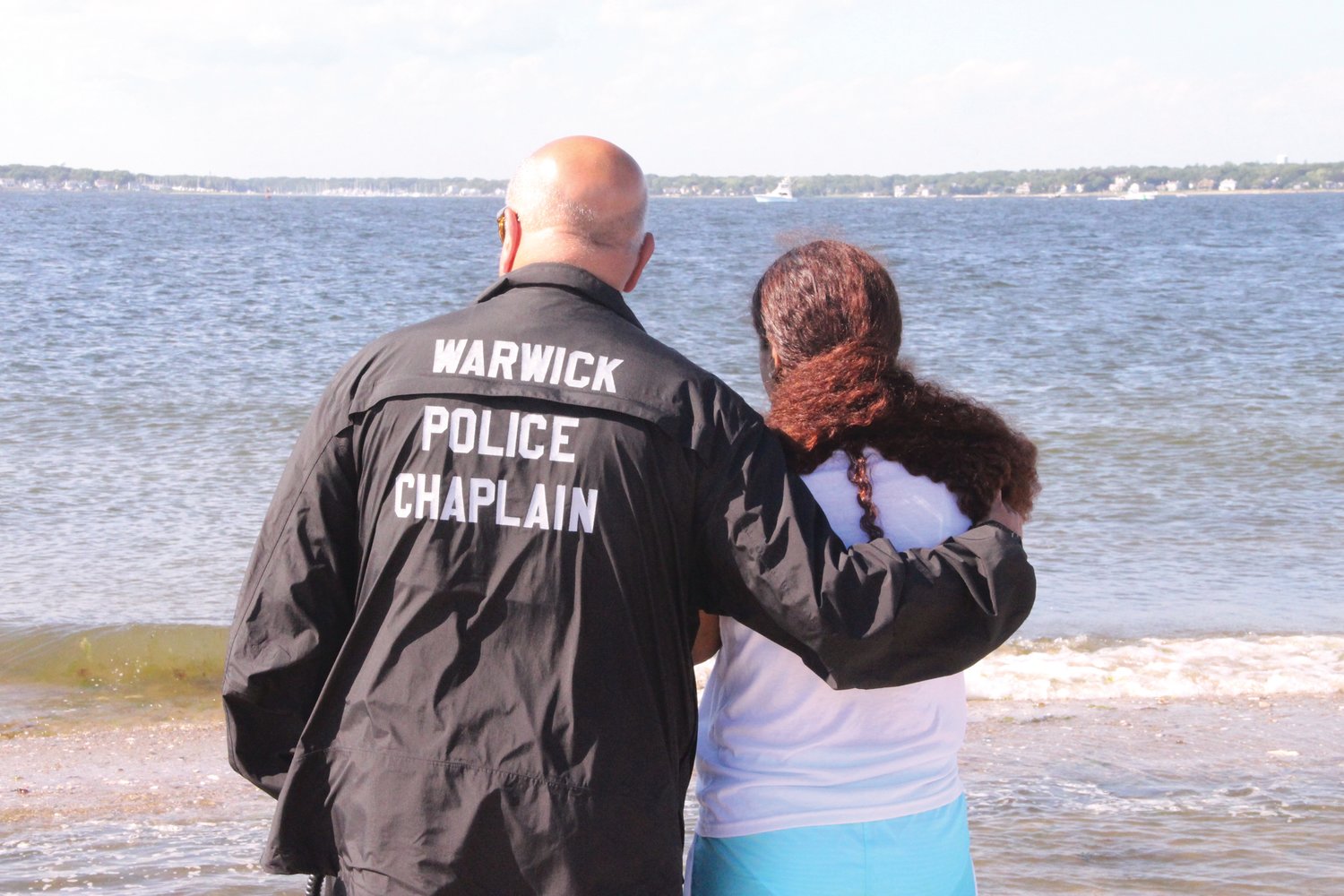 SUPPORTING PRAYER: Father Robert Marciano, police and fire chaplain joined Yosekarly’s mother Carla Martinez to pray Sunday afternoon at the point.