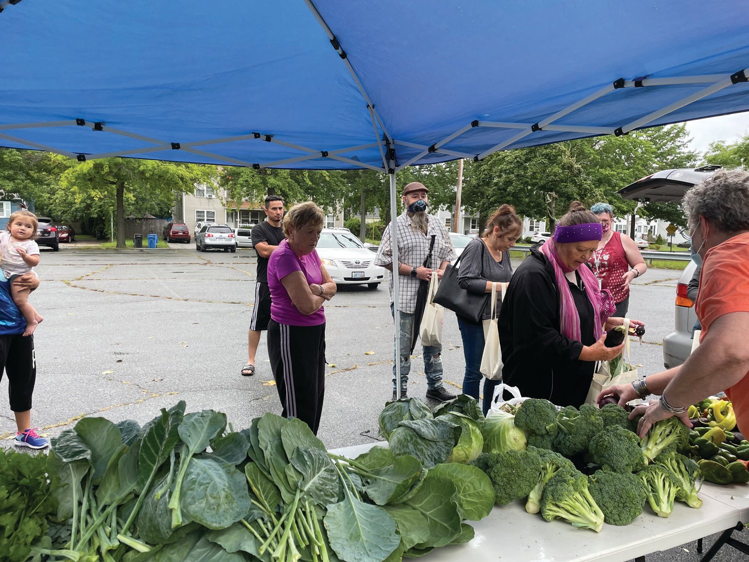 GETTING THE GOOD STUFF: Cranston residents wait patiently for their turn at the OneCranston HEZ farmers market. 