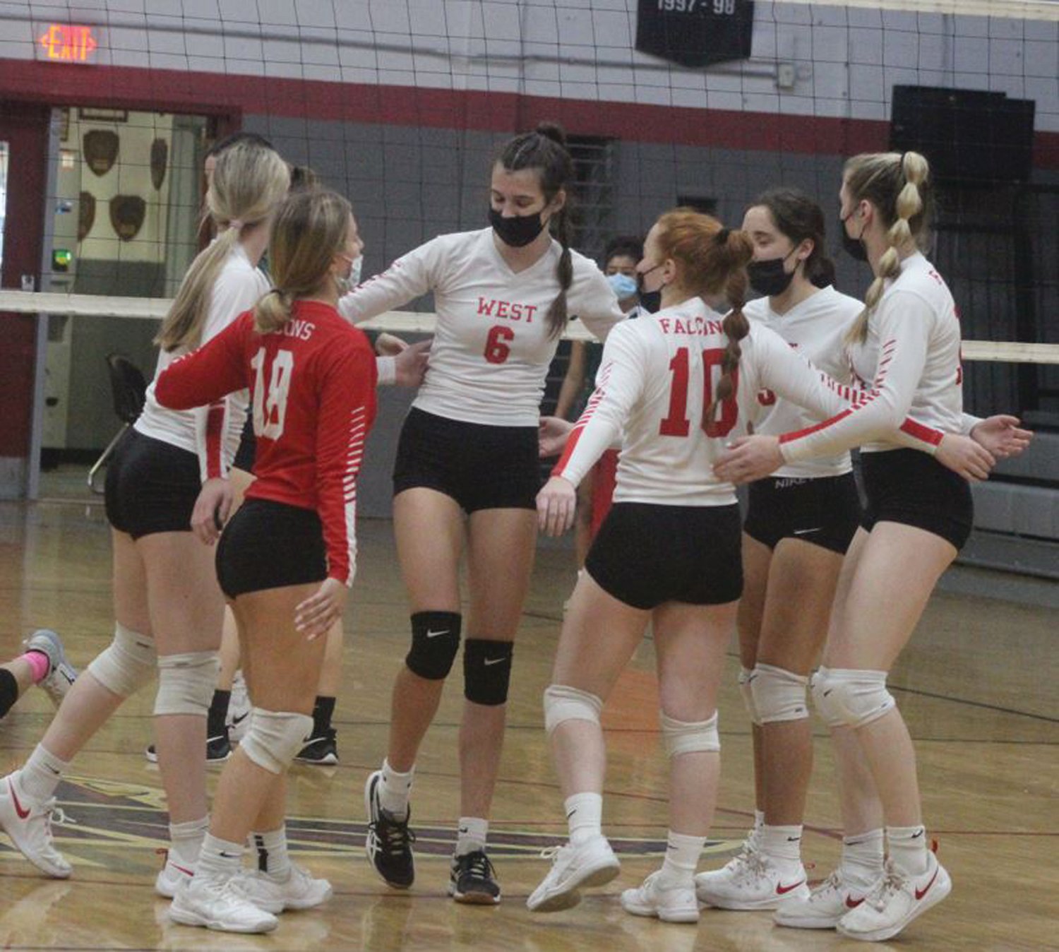 GETTING THE WIN: Members of the Cranston West girls volleyball team celebrate. (Photos by Alex Sponseller)