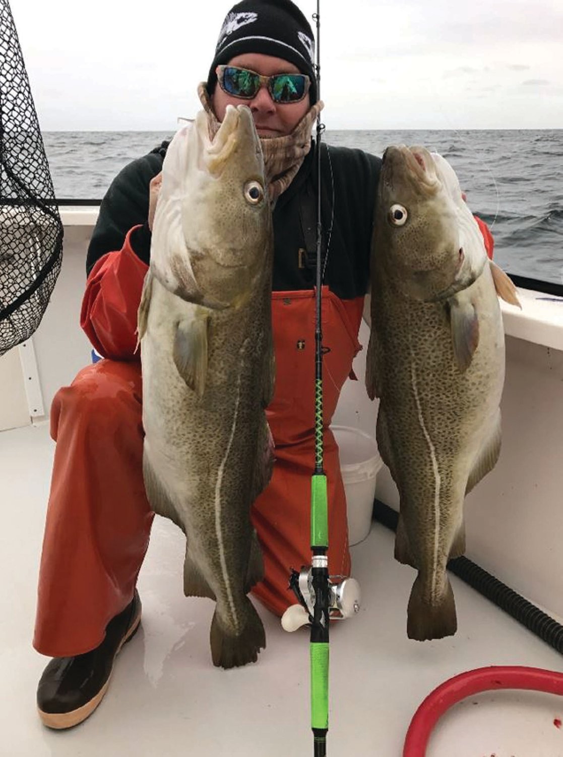 DOUBLE TROUBLE: Capt. Wade Baker of Booked Off Charters with a pair of 25 pound cod jigged up in January.