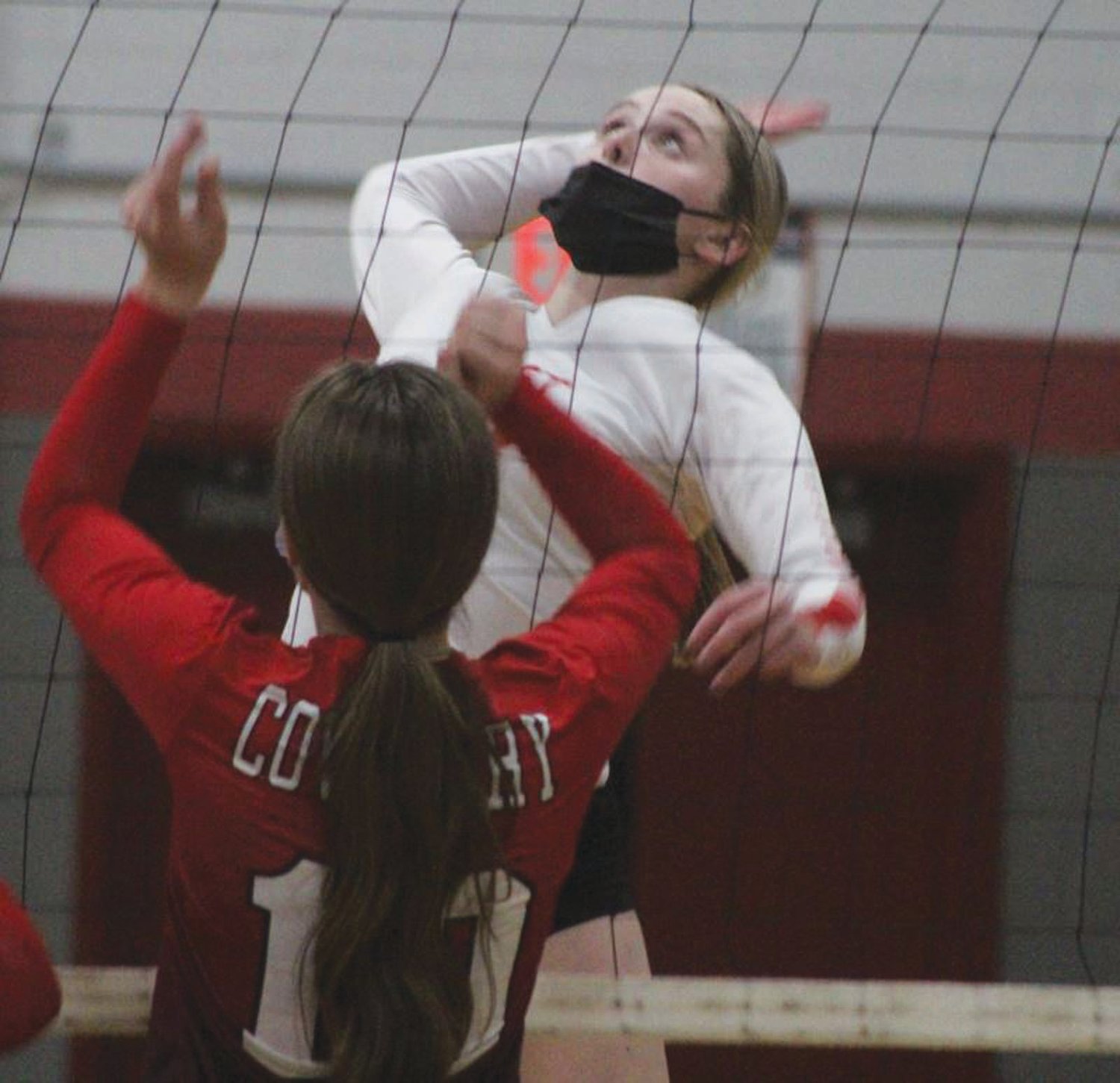 SPIKE: Cranston West’s Emily Bessette leaps to spike
the ball on Monday.