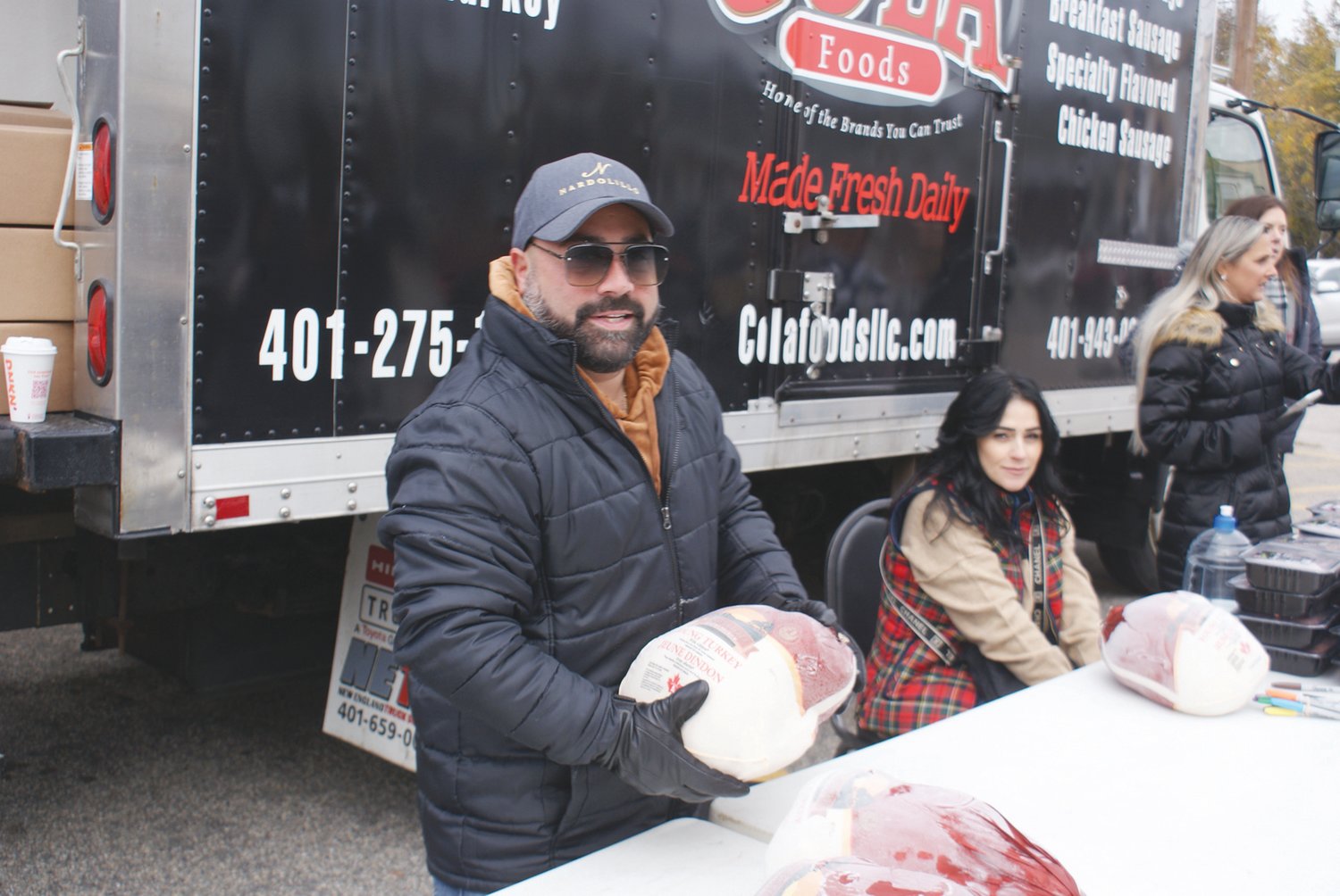 VOLUNTEER: Volunteering at the Free Turkey at the St. Mary’s Feast Society was Ann Marie Harty along with Ryan Nardolillo.