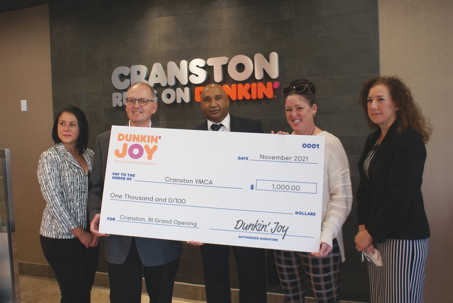 CHECK PRESENTATION: Bill Senecal (Director of Operations for Dunkin) presented a check in the amount of $1,000 to the Cranston YMCA on behalf of Fatima Dutra, Franchisee of the Dunkin location (not pictured), along with Citywide Council Woman Nicole Renzulli, Franklin Paolino (Director of Cranston Dept. of Economic Development) and Citywide Council Woman Jessica Marino.