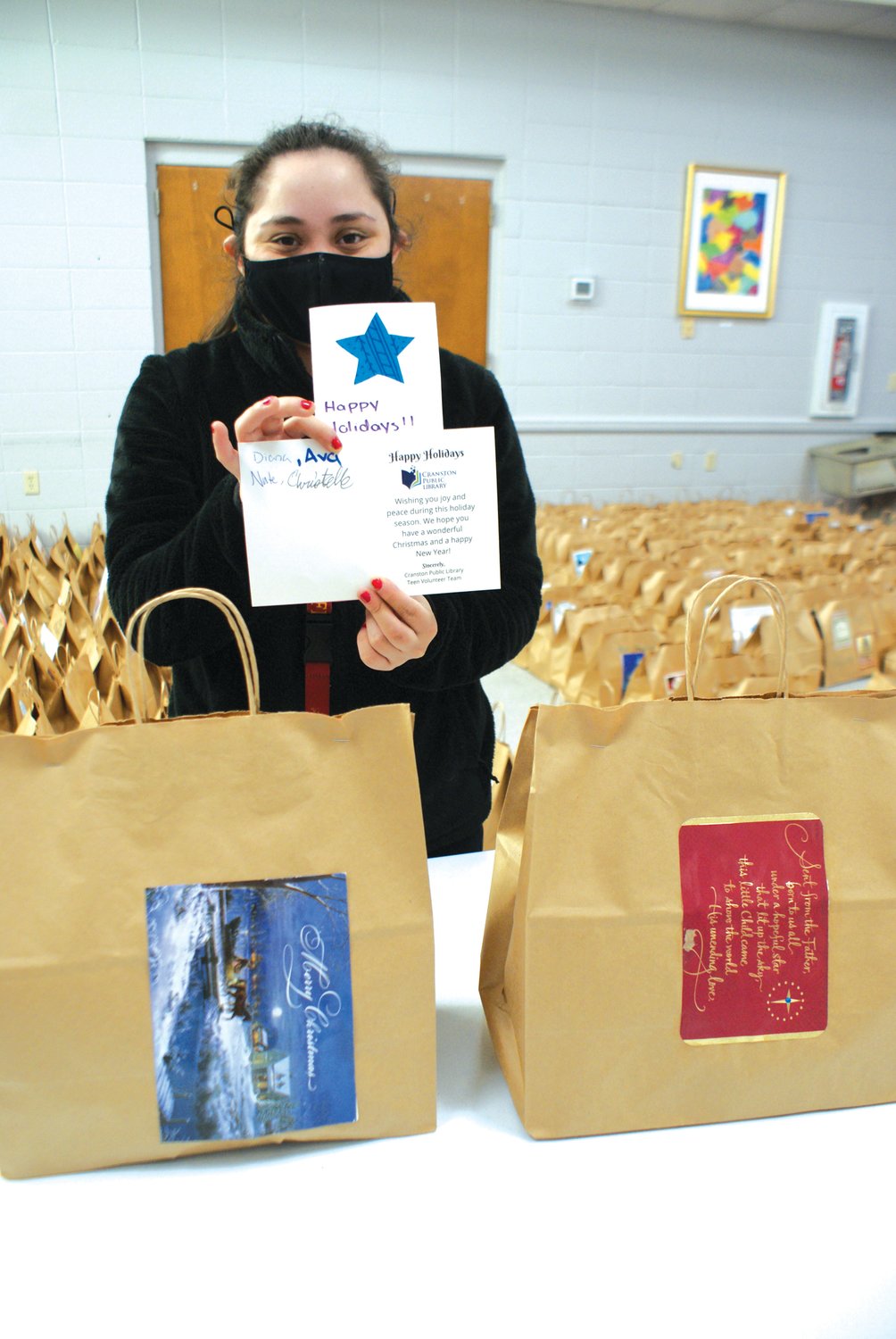 READ TO WORK: Emily Sanipa, of Cranston, showed just
one of 600 cards made for both Thanksgiving and Christmas
Dinner Give-a-ways. The cards were made by Cranston
School children and attendees at the Cranston Library Youth
Programsa