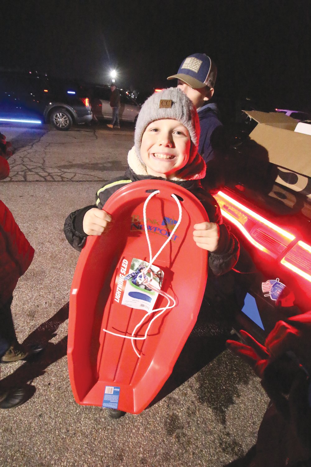 READY FOR SNOW: Sam Barnatowicz flashes a smile after winning one of several sleds provided as prizes in a raffle sponsored by BankNewport.