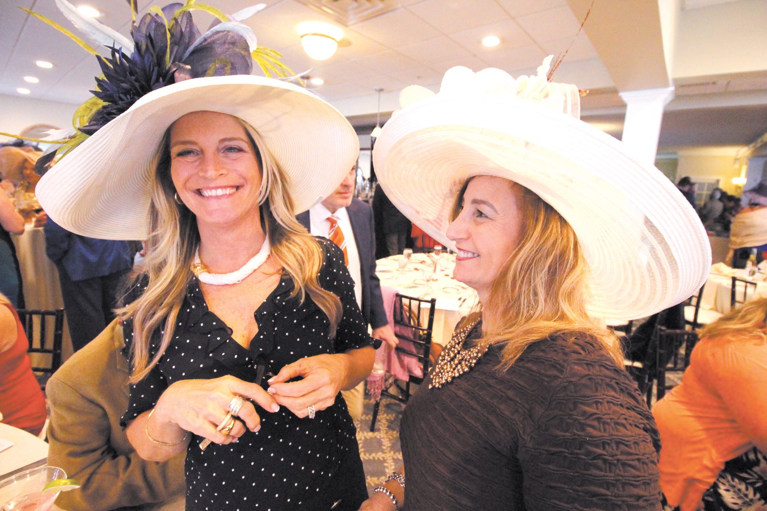 HAT TRICK: Tina Schadone and Maria Lanni stood out in their hats worn for a first time Saturday at the Warwick Country Club.