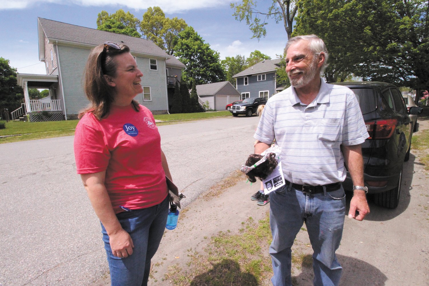 NO LACK OF OPINION: Warwick resident Dan Kugler offers his views of what’s not working to Congressional District 2 Democratic candidate Joy Fox, as Fox walked the Norwood neighborhood Saturday.