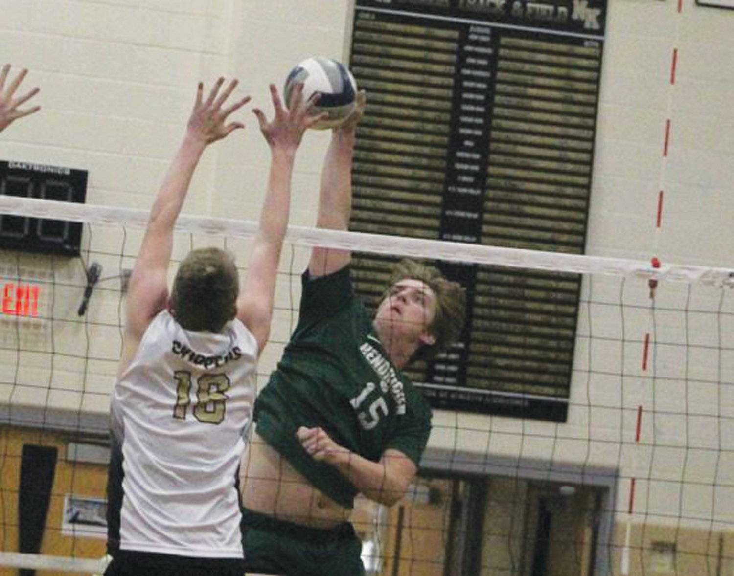 AT THE NET: Hendricken’s Ryan Osley goes for a shot.