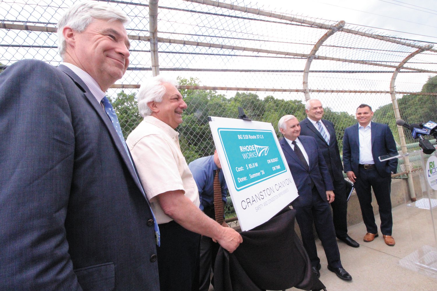 SIGNS OF WORK TO COME: On the Phenix Ave. bridge in Cranston overlooking Route 295, state and federal officials gathered Friday to announce the $85 million Cranston Canyon Project. Pictured are Senator Sheldon Whitehouse, DOT Director Peter Alviti, Senator Jack Reed, Carlos Machado, district director of the U. S. Department of Transportation Federal Highway Administration and Rep. Brandon Potter of Cranston. (Cranston Herald photo)