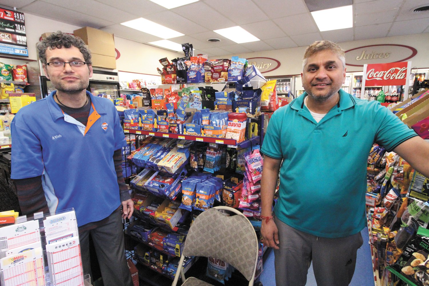 PENNY PINCHING: Brothers Eddie and Andy Patel, who run the Gulf Express convenience store in Conimicut have seen gas sales drop with many more customers opting to pay the lower cash price than using credit.  (Warwick Beacon photo)