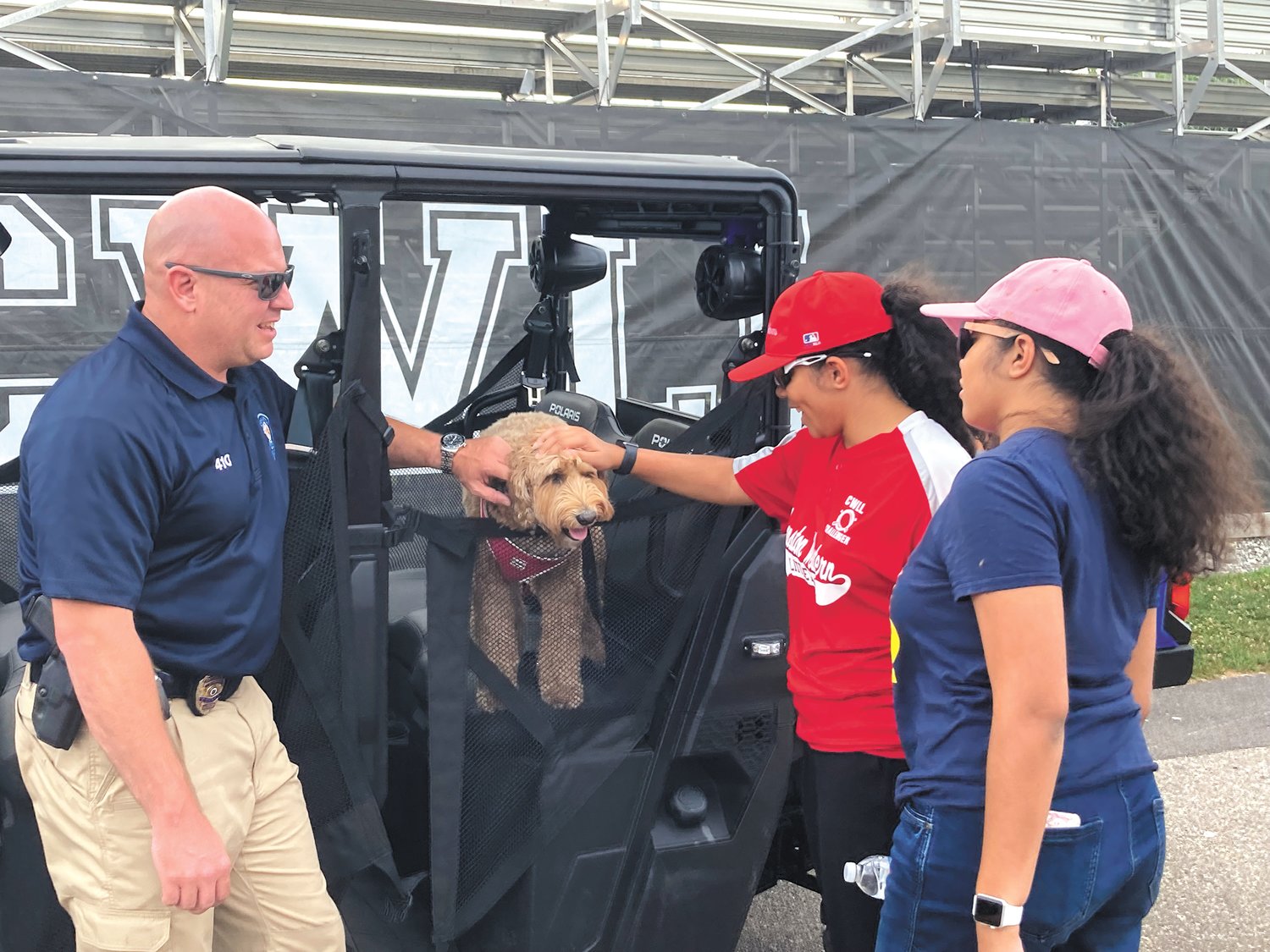 TAKING IT IN: Cali, a three-year-old Australian labradoodle, made an appearance at the Challenger's season finale. (Herald photo)