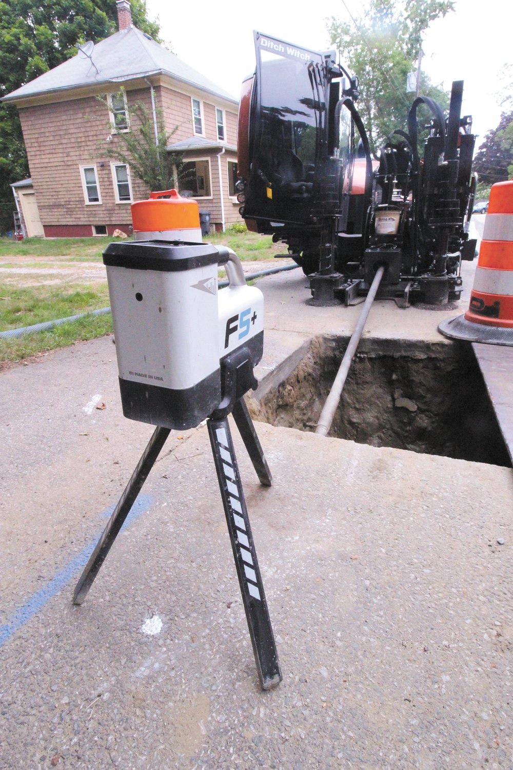 KEEPING TRACK: Using telemetry from the head of the drill and a transmitter positioned over white dots to indicated the desired path of the subsurface line, the operator is able to tell whether the boring on line and make adjustments as they go. On an average 300 feet of pipe is installed a day.