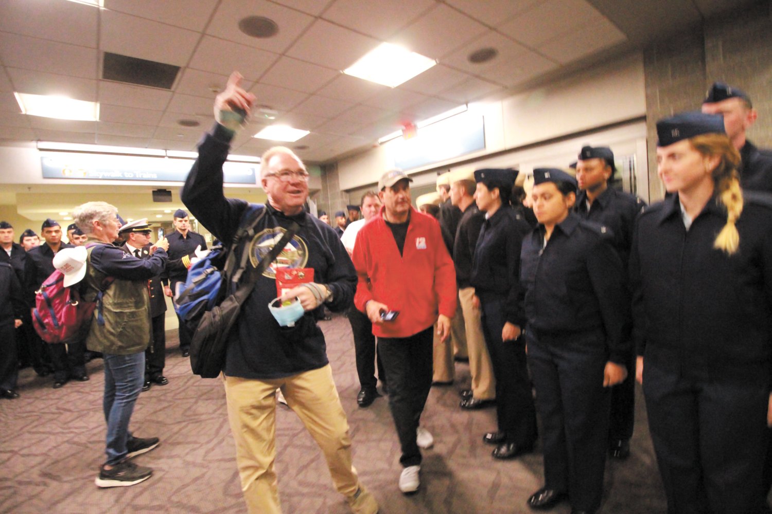 STRIKE UP THE BAND: Signaling that members of Flight Thunderbolt held Oct. 15  are entering the terminal, George Farrell calls on the pipes and drums to play.