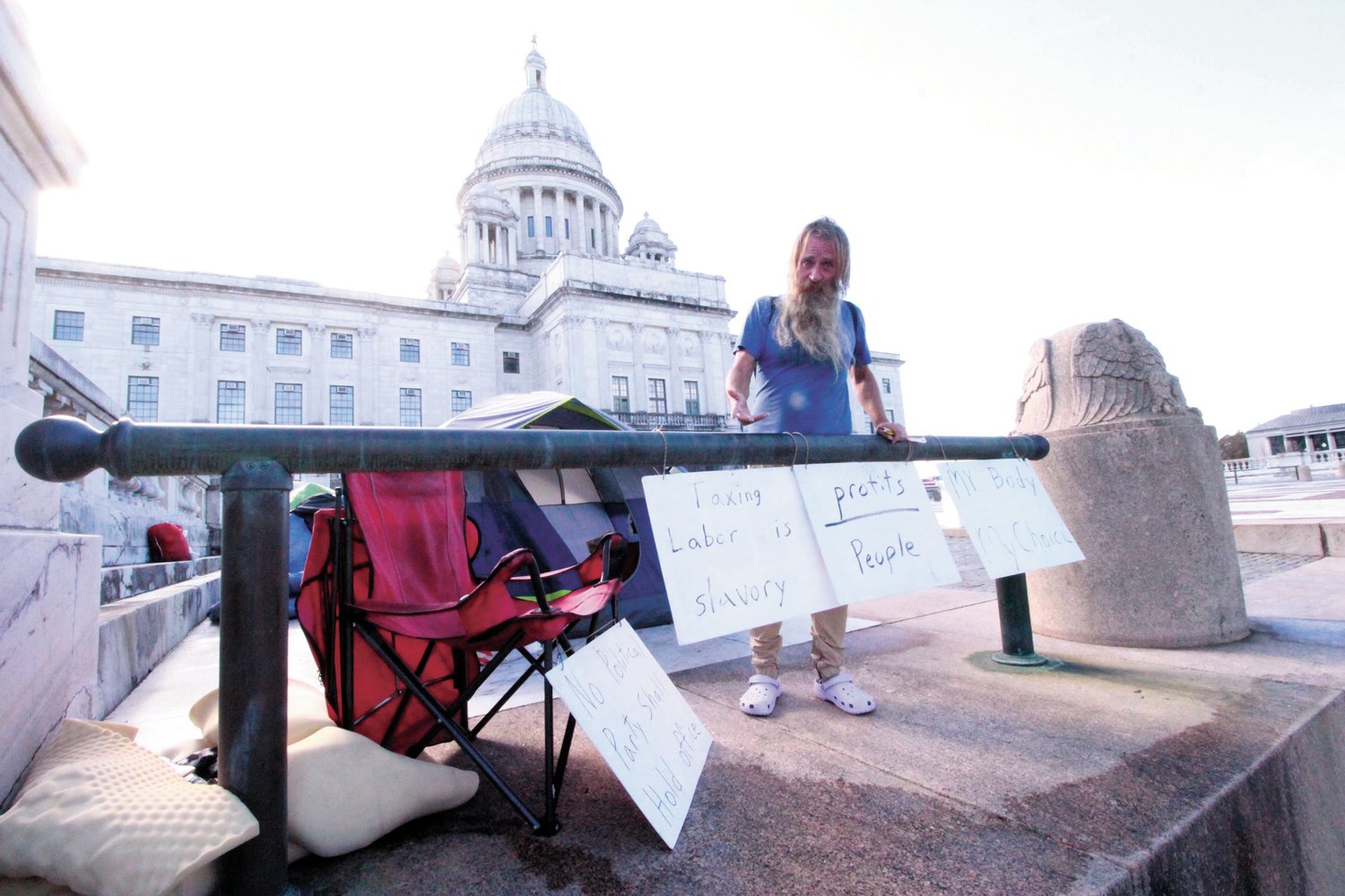 STATE HOUSE ENCAMPMENT: Michael Nugent one of the homeless who have pitched tents in front of the State House does not see pallet housing as a means of addressing the homeless population. (Herald photo)