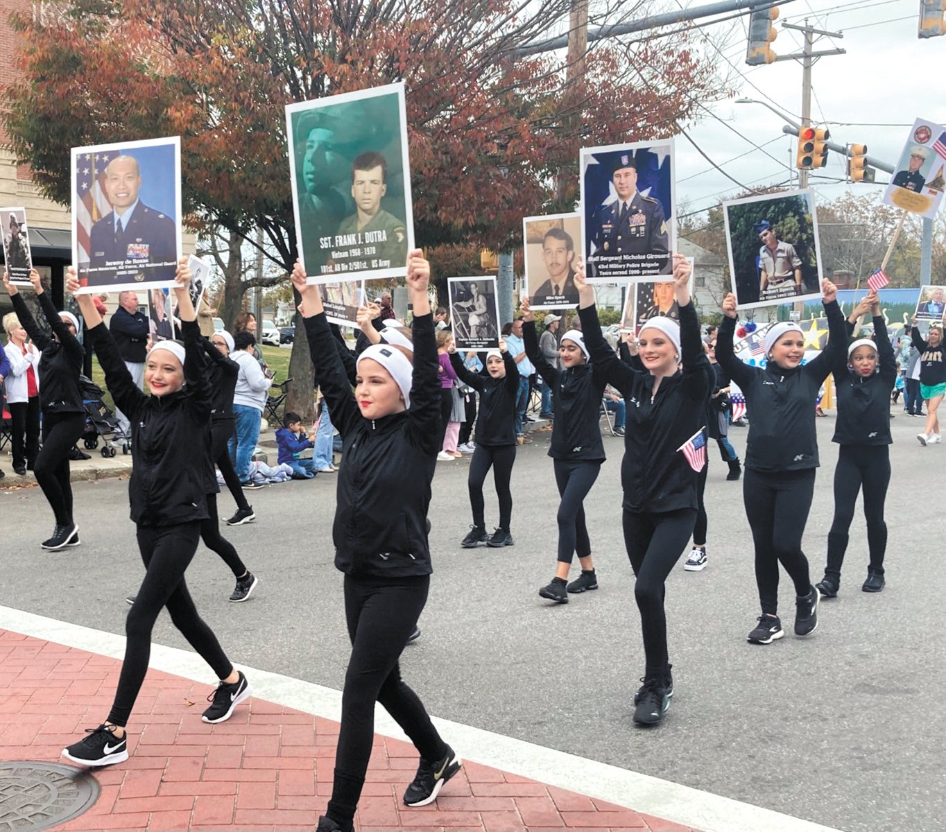 VETERANS PROFILED: Carolyn Dutra Dance Studio dancers walking in the parade held signs with veterans on them. (Herald photos)