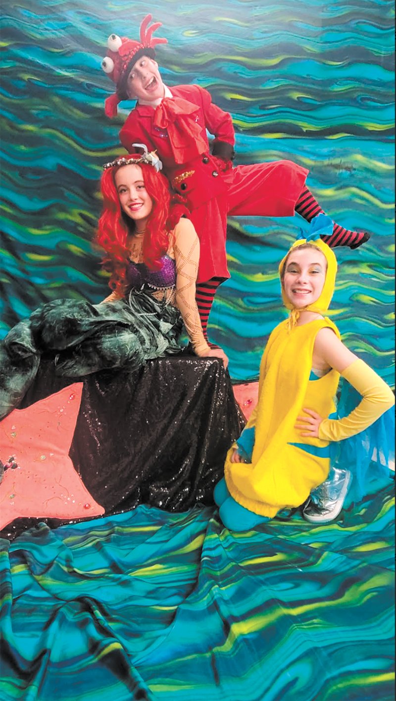 IN THE WAVES: Paige Carter, Connor Laflamme, and Charlotte McMahon in a scene from The Little Mermaid Jr. performed by St. Rose of Lima students.