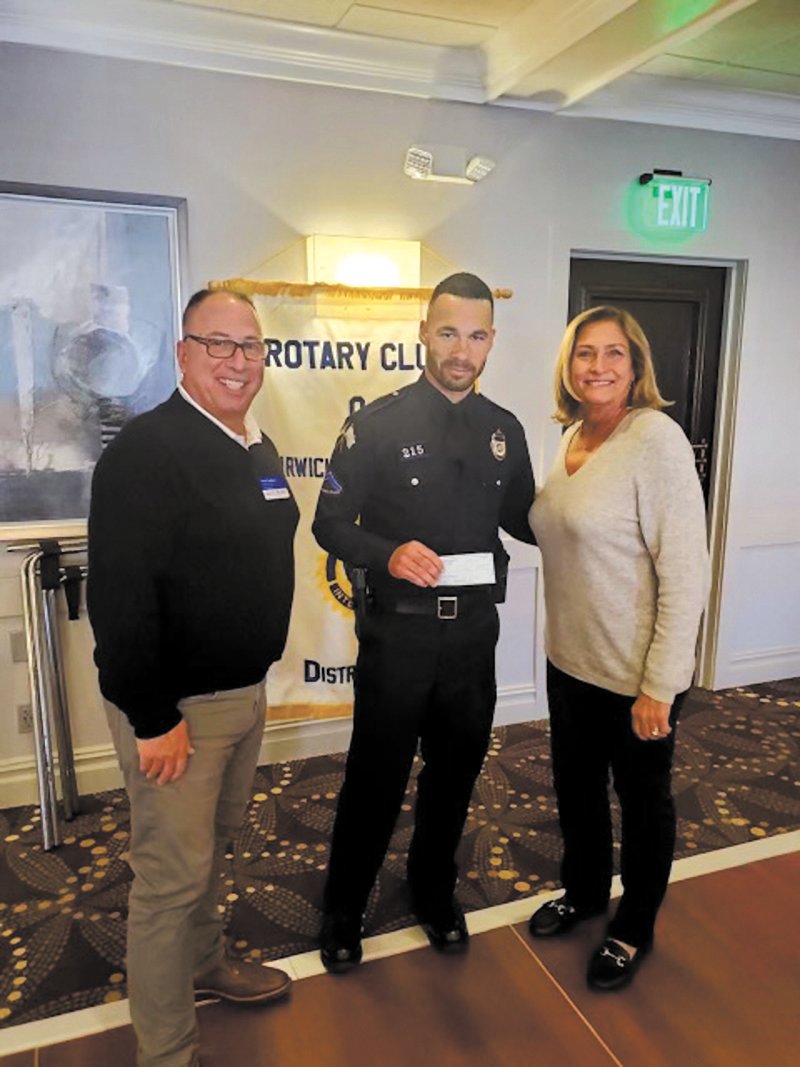A BIG BOOST TO PAL: The Warwick Rotary Club recently awarded the Warwick Police Athletic League $10,000 to assist in running the programs it started in 1971. In addition to its athletic programs, PAL mentors kids providing them with moral support and advice. Pictured with Officer Russell Brown who runs PAL are Scott Seaback, president of the Rotary Club and Janis Constantine, chair of the club’s charity committee. (Photo courtesy of the Warwick Police Department)
