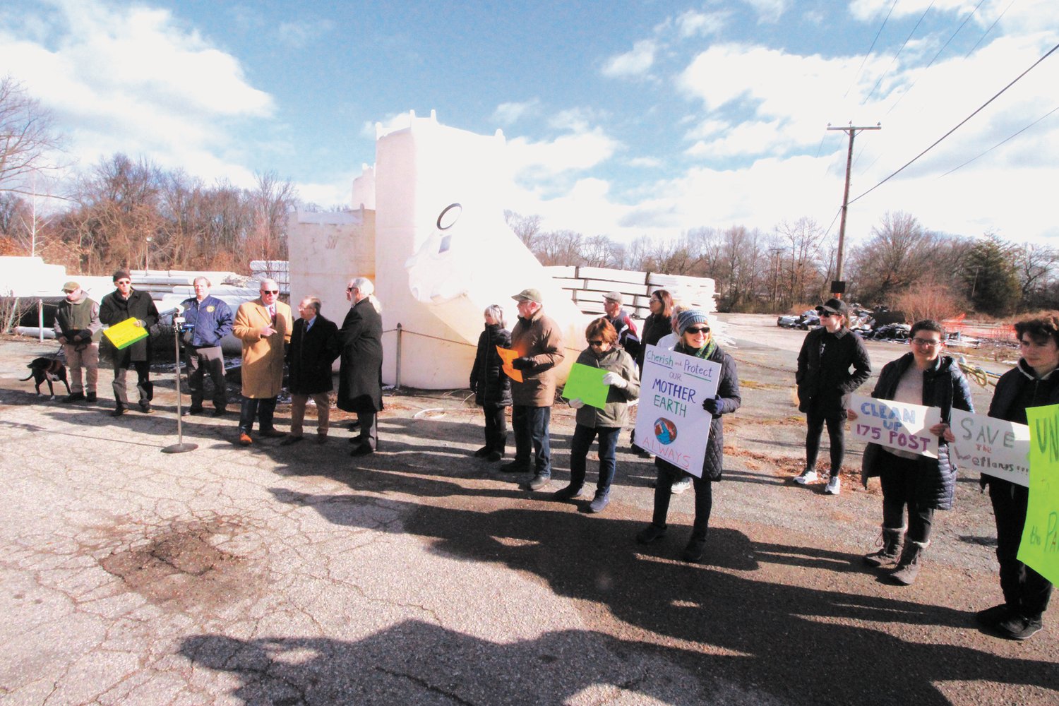WHAT HAPPENS IF THERE’S A FLOOD? Lined up on Venturi Avenue in Pawtuxet, site of a proposed development that contractors would rent for the storage of equipment, state legislators joined by residents voice concerns over possible flooding of the property and what would become of the PVC pipes and tanks now stored there. (Cranston Herald photo)