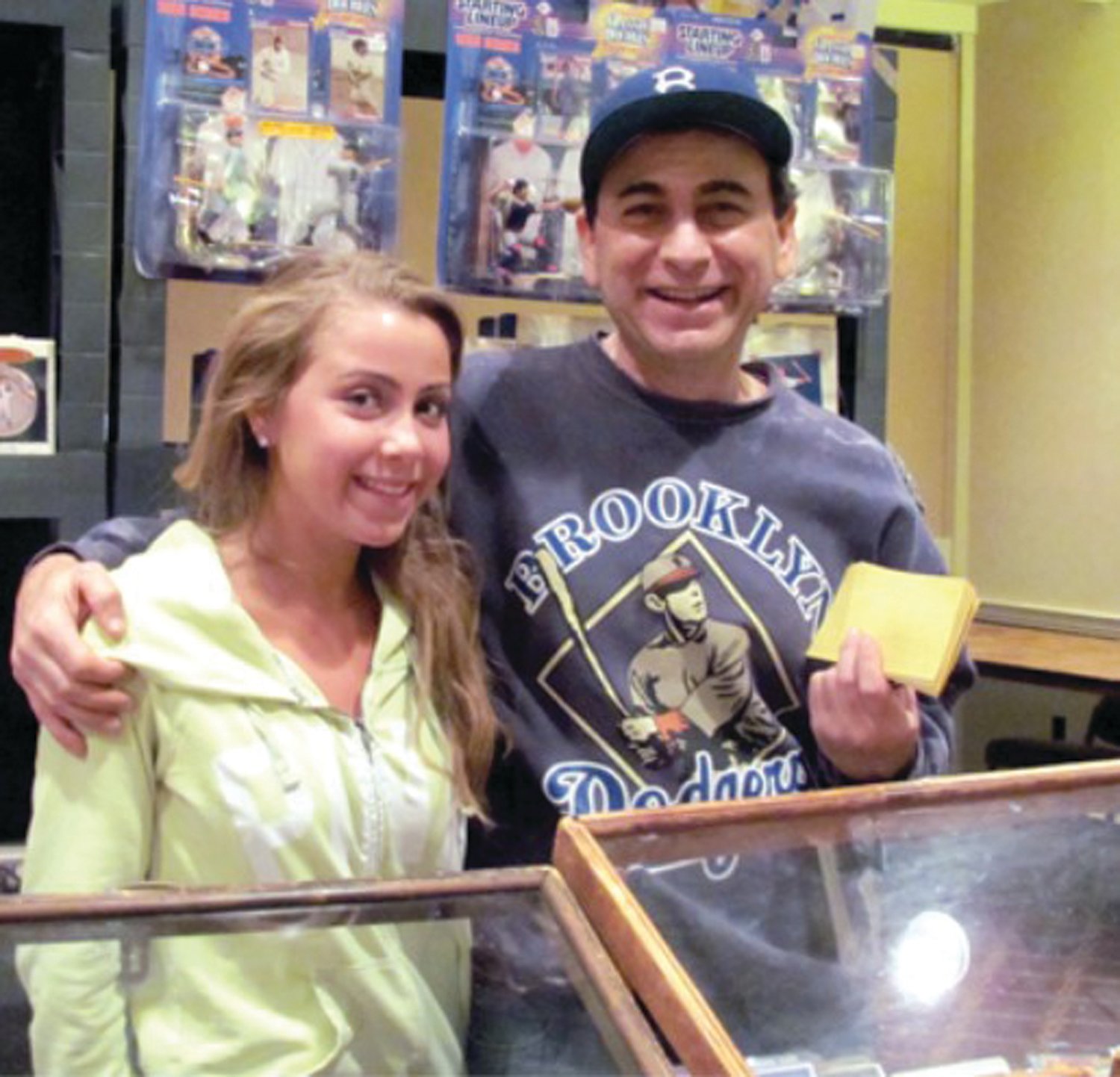 PROMOTER: Before Mike Mangasarian was a promoter, he was a dealer holding the most prominent first three tables at the entrance of the Cranston Card Show. He is seen here with his 17-year-old daughter Margo in 2012 at the West Valley Inn.