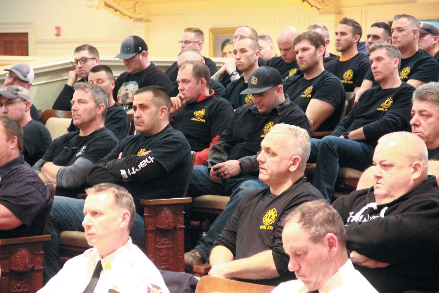 WHAT IT MEANS TO THEM: Warwick firefighters follow the discussion leading up to council ratification of a three-year contract.